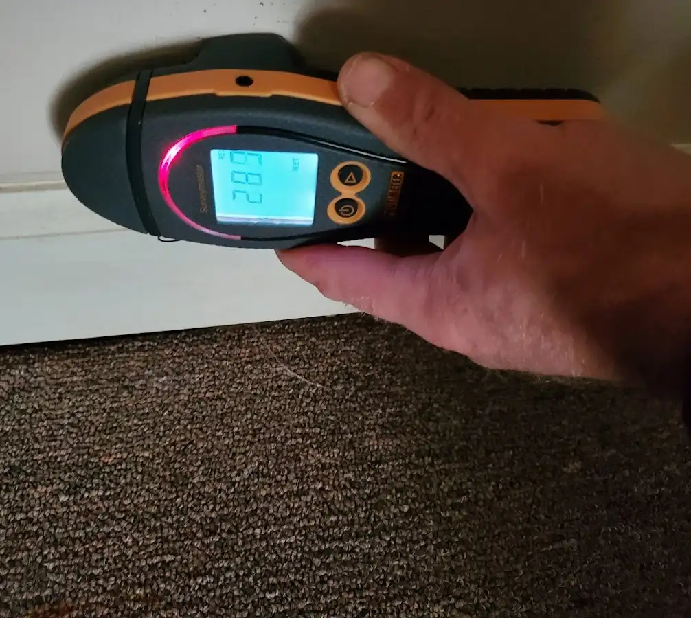 Moisture detection at baseboard during Storm Damage Restoration in Walden